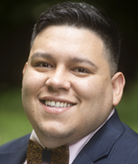 Man with suit and bowtie, smiling at the camera